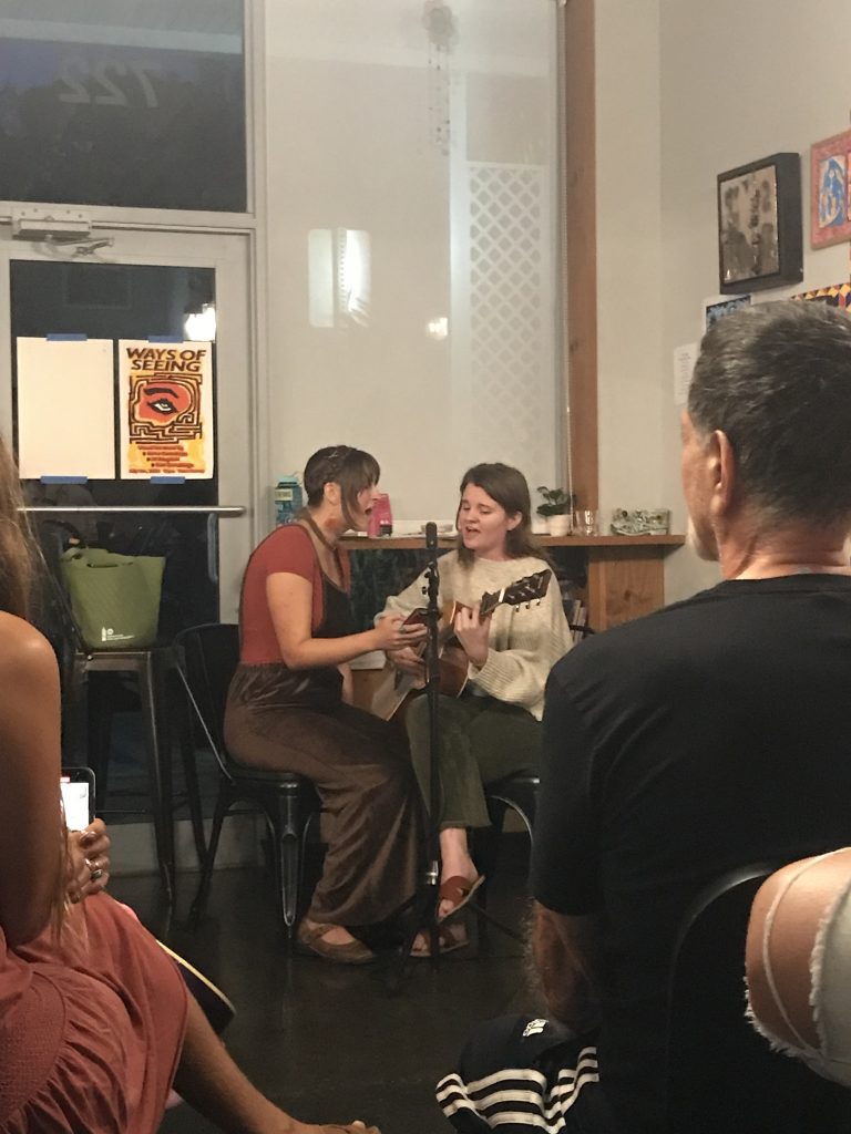 Two performers at the open mic night in South Florida at Hani Honey, sharing music and poetry with the audience